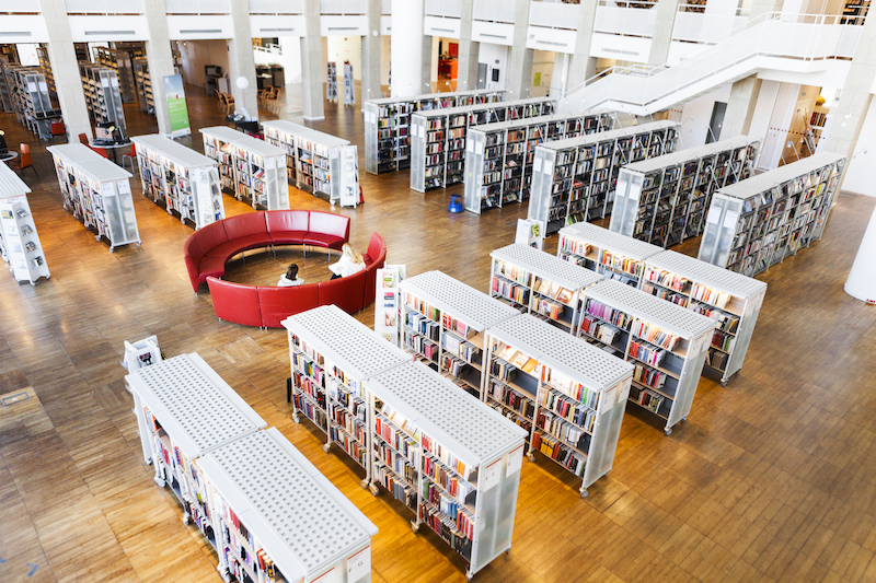 High angle view of women sitting on sofa in library