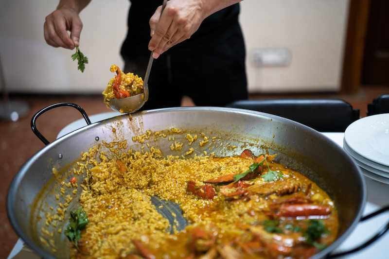 man serving paella