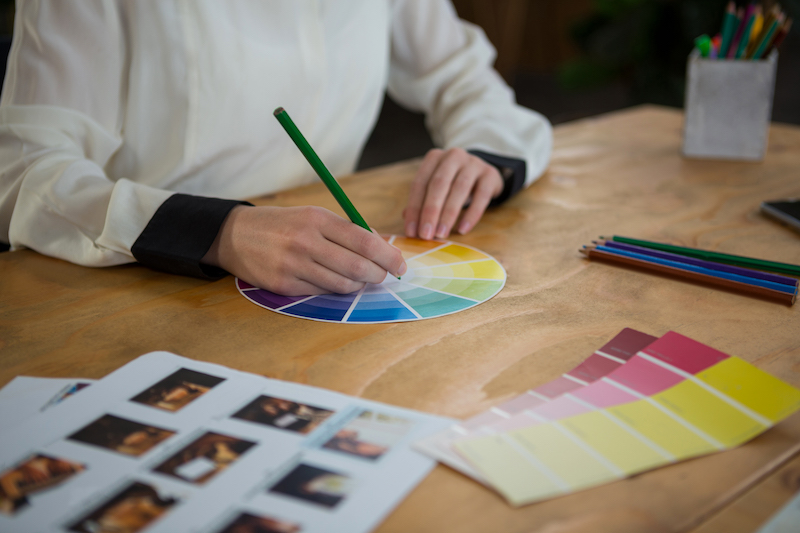 Close-up of a female graphic designer working at desk in creative office