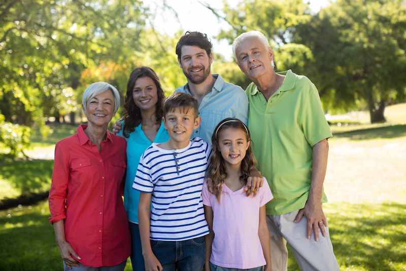 Portrait of happy family enjoying in park on sunny a day