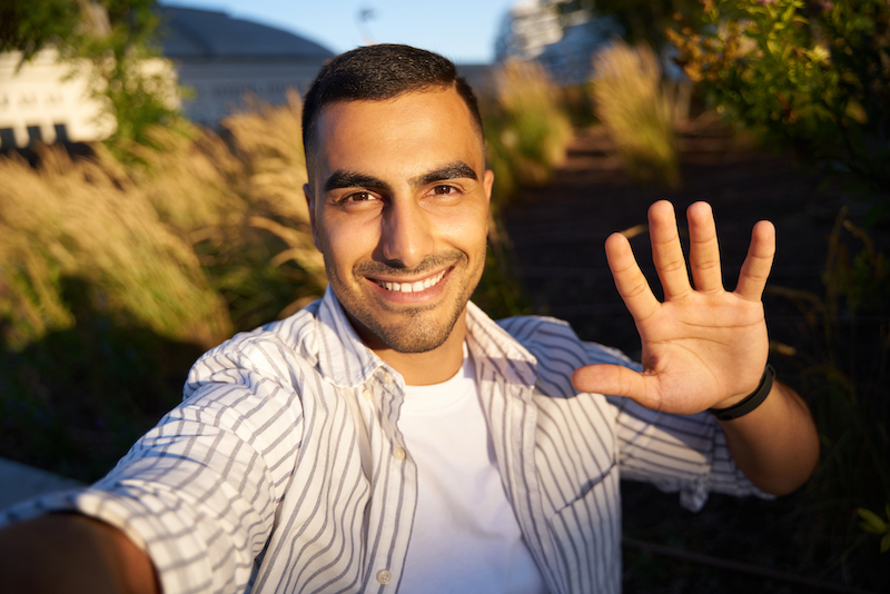 smiling man waving