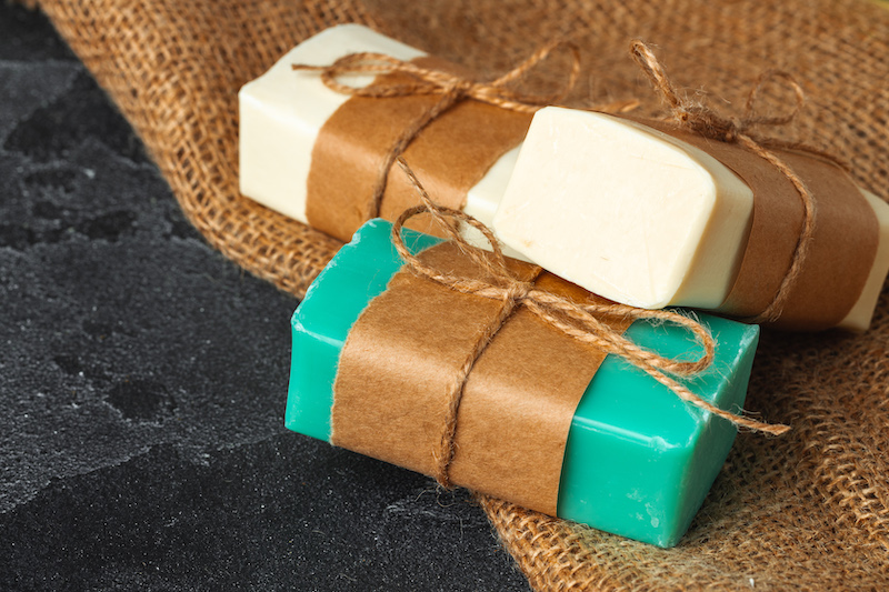 Soap bars with natural ingredients on the table, close up.