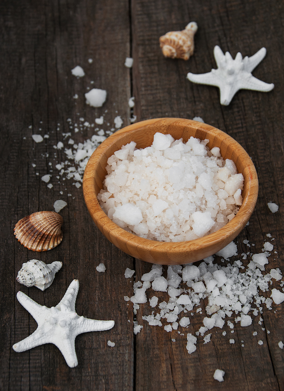 Bowl with massage salt on a old wooden table