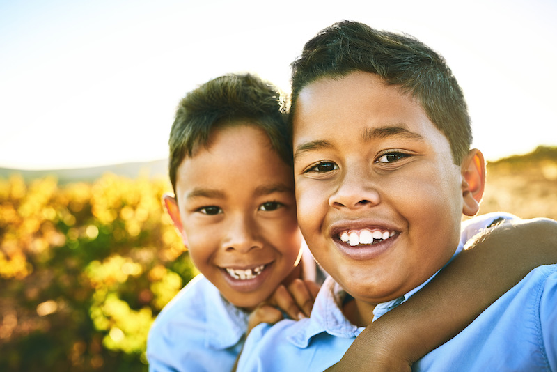 Brothers out and about. Portrait of two little brothers taking a selfie together outdoors