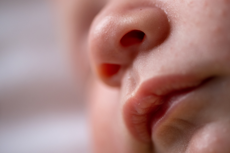 Macro shot of an infant's sleeping face. 