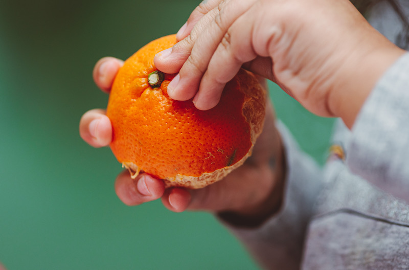 girl peeling orange