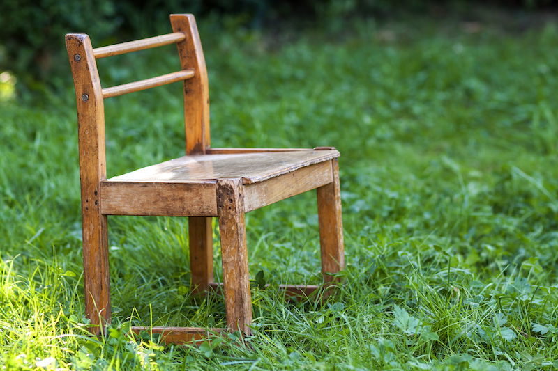 Little old chair on green grass