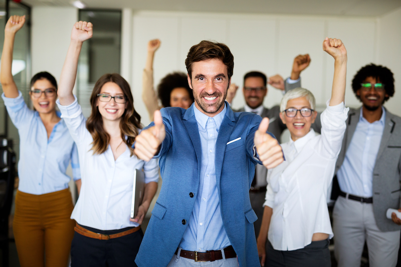 Group of successful happy multiethnic business people celebrating a good job in the office