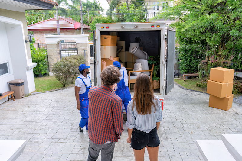 Professional goods move service use truck carry personal belongings door to door transport delivery handover boxes luggage one by one and keep stack on the floor before transfer to place in house