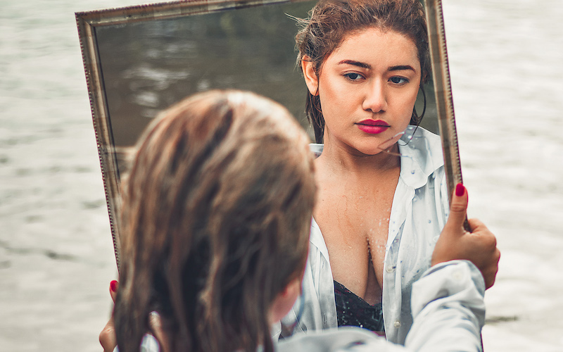 lady looking at herself in the mirror