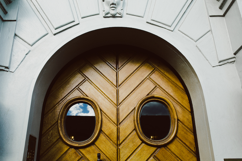 wooden doors with round windows in beautiful building in stockholm, sweden