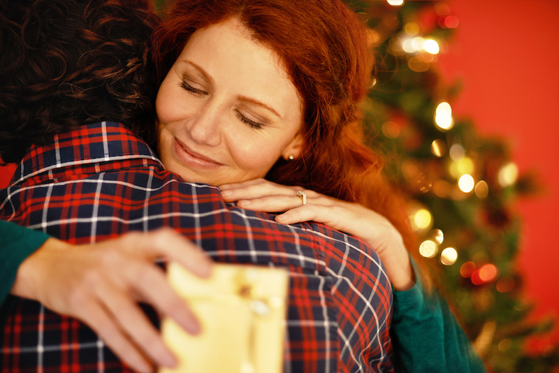 Shot of a young woman embracing her boyfriend after receiving a gift from him.