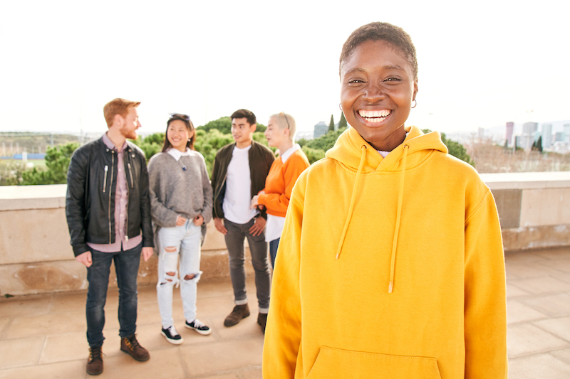 young people standing and smiling