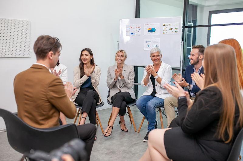 male and female colleagues talking at work