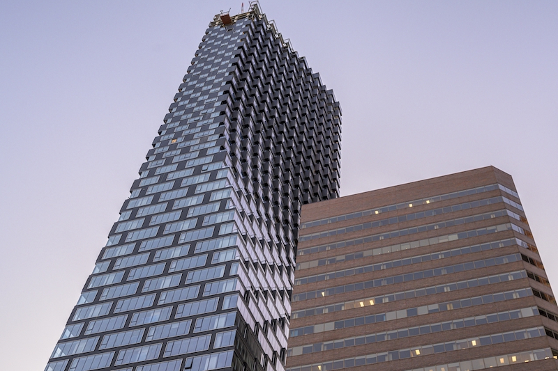 A low angle shot of Telus Sky tower captured under the blue sky in Calgary, Alberta, Canada