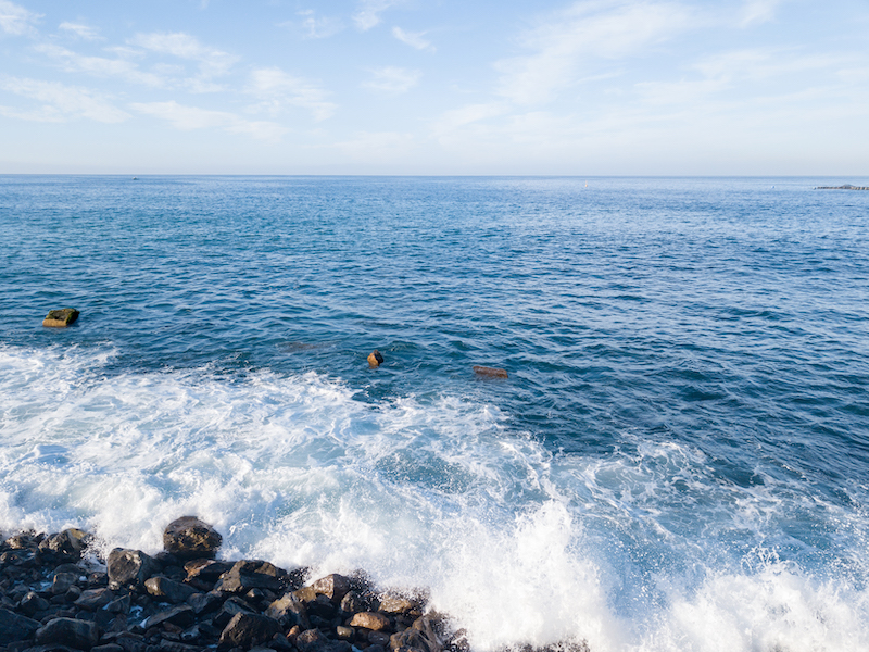 Rocky beach with Atlantic Ocean waves meeting with underwater sharp rocks