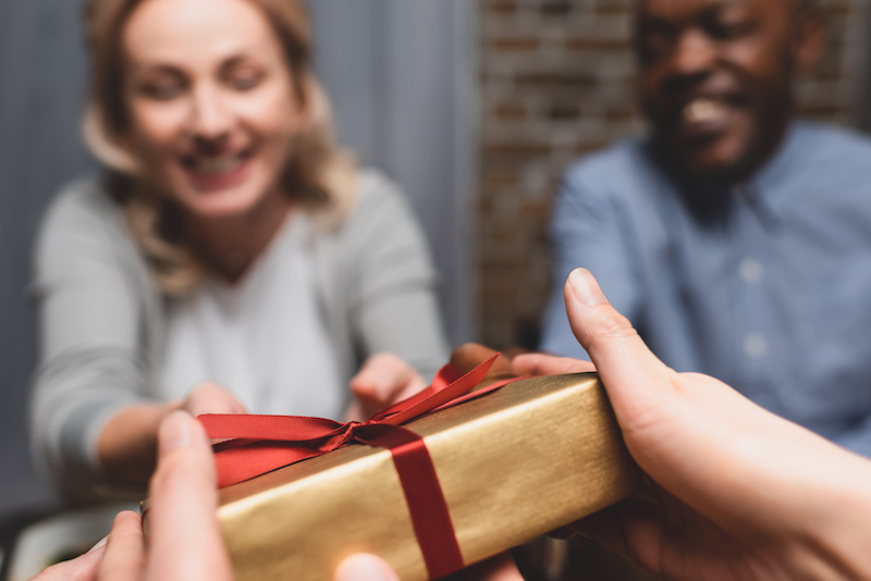 woman giving present to friend